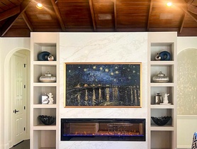 Frame TV in art mode, speakers custom color matched to woodwork, Control4 lighting control and automation.