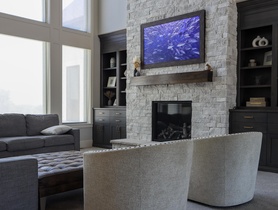 Featured in this room are 2 Sonance invisible speakers above the bookshelves on both sides of the fire place.