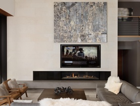 This room features an 85" TV that is concealed behind a large art piece that automatically lifts and lowers.