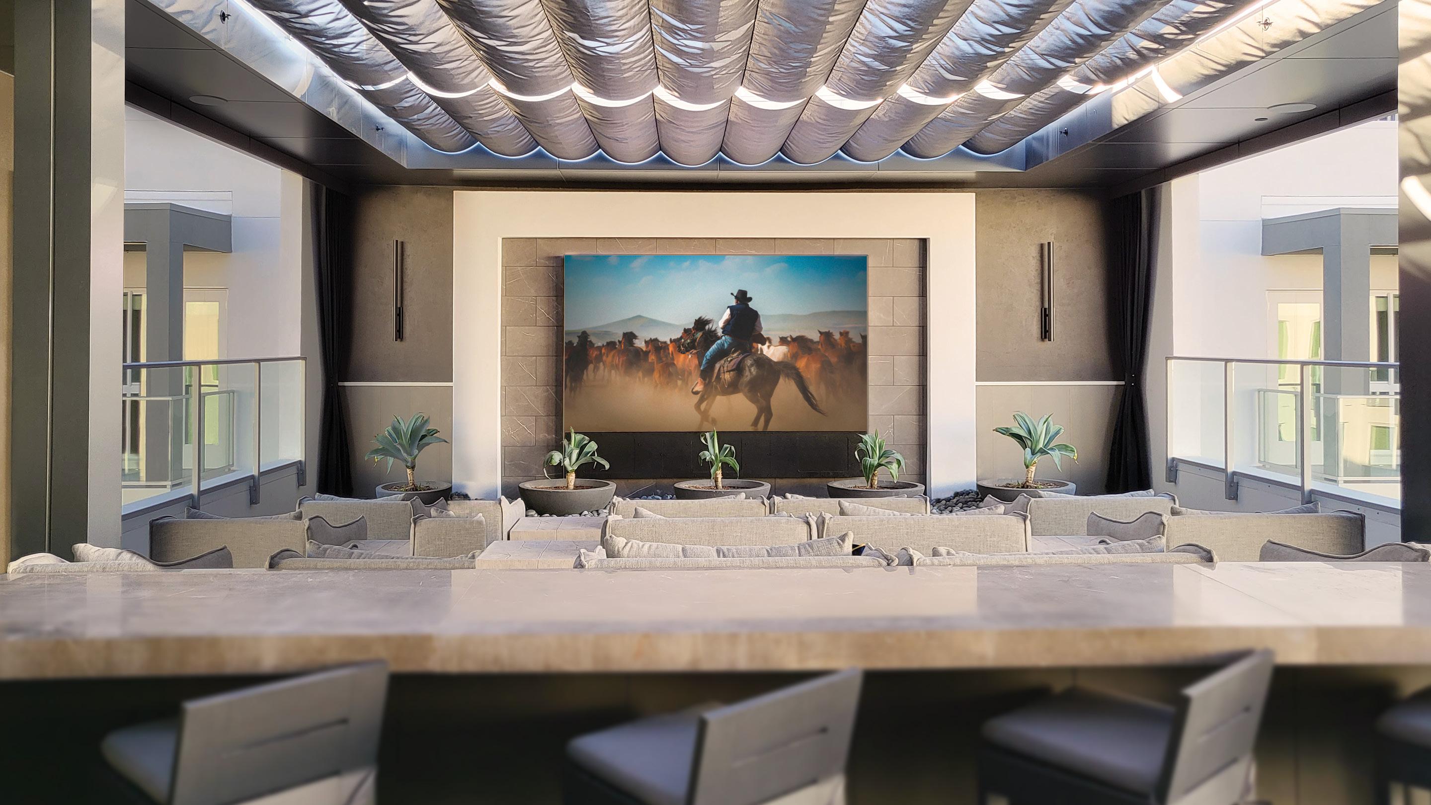 Stealth Acoustics Stunning Stealth Patio Theater 137" outdoor LED TV with sound bar.